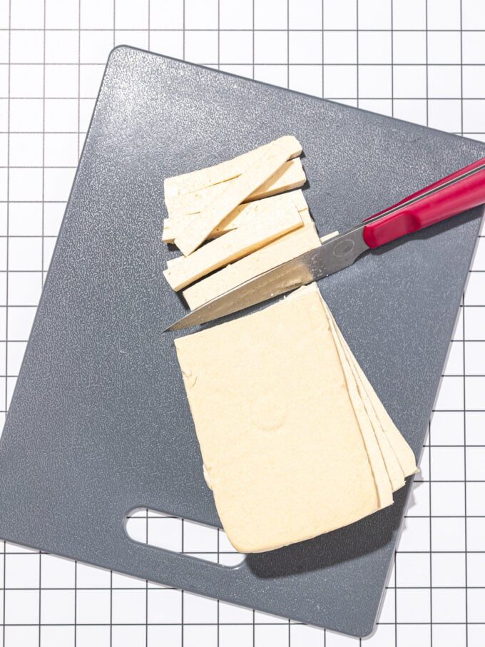 knife slicing tofu into matchsticks